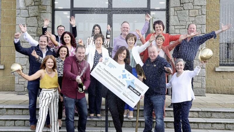 Michelle O&rsquo;Hare, Gareth Tinnelly and members of the Tinnelly Group Lottery Syndicate celebrate their &pound;253,489.30 EuroMillions win at the demolition company&#39;s headquarters in Newry. 