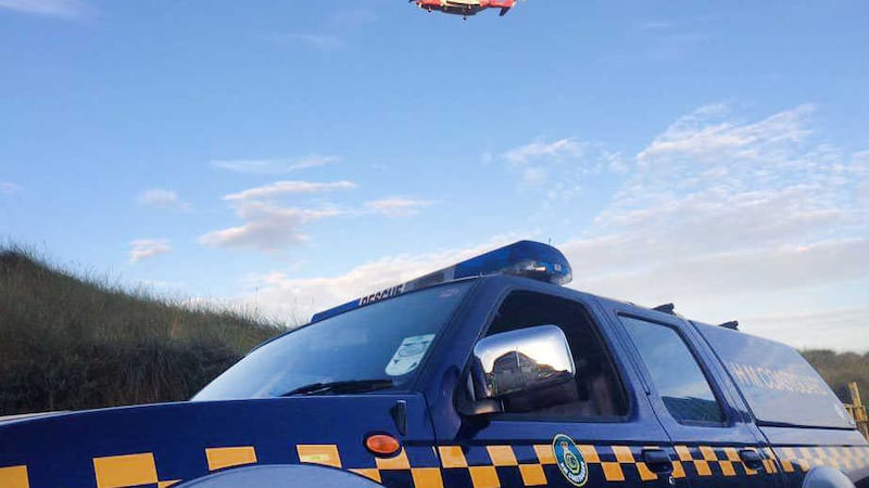 A woman has been rescued by the coastguard, navy and lifeboats after becoming trapped on cliffs near Islandmagee