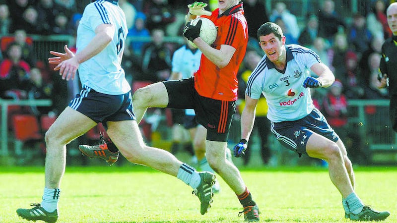 Niall McParland in action against Dublin&#39;s Ger Brennan and Rory O&#39;Carroll during the National Football League in 2012, McParland says one of Down&#39;s key aims is survival in Division One this season 