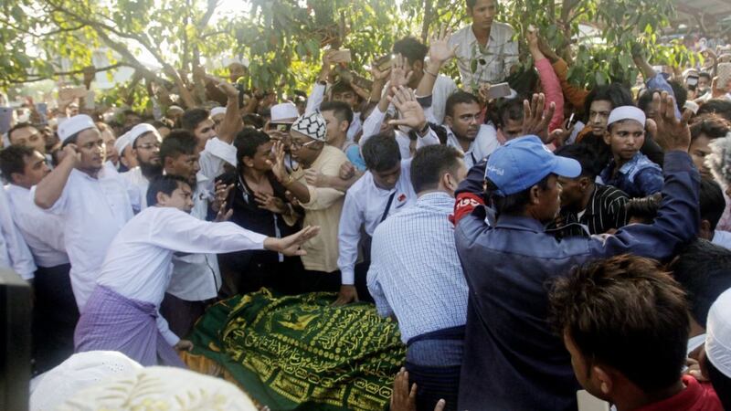 People crowd as they try to bury the body of Ko Ni who was assassinated by a gunman on Sunday, during a funeral at a cemetery Monday, Jan.30, 2017, in Yangon, Myanmar. Picture by Thein Zaw, AP Photo