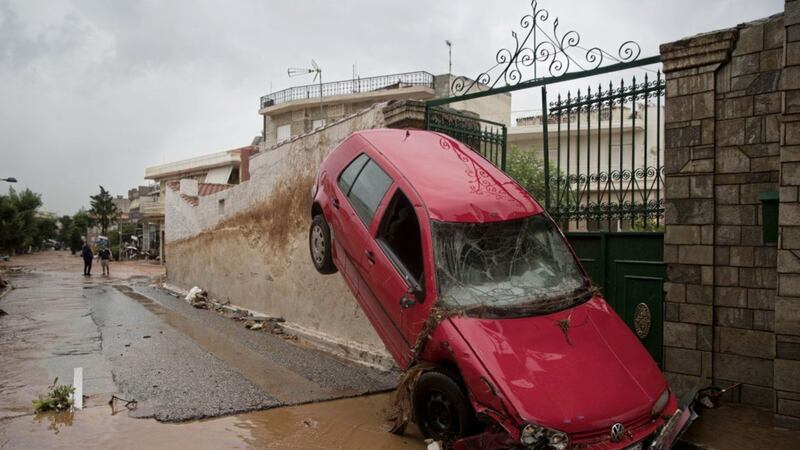 A washed up car is lodged at the entrance of a house in the municipality of Mandra western Athens Petros Giannakouris/AP 