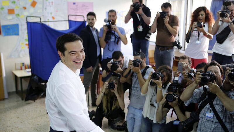 Greece&#39;s Prime Minister Alexis Tsipras casts his vote at a polling station in Athens yesterday 