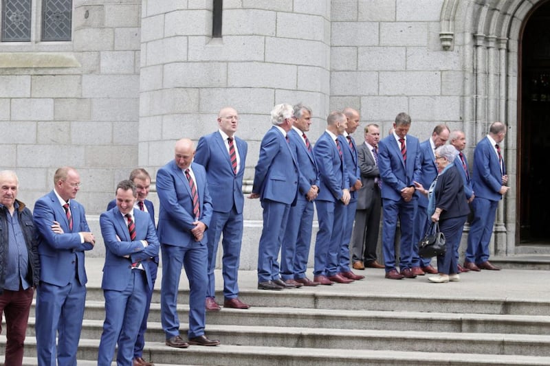 A guard of honour by former Down GAA players was formed on the steps of Newry Cathedral .Picture by Mal McCann