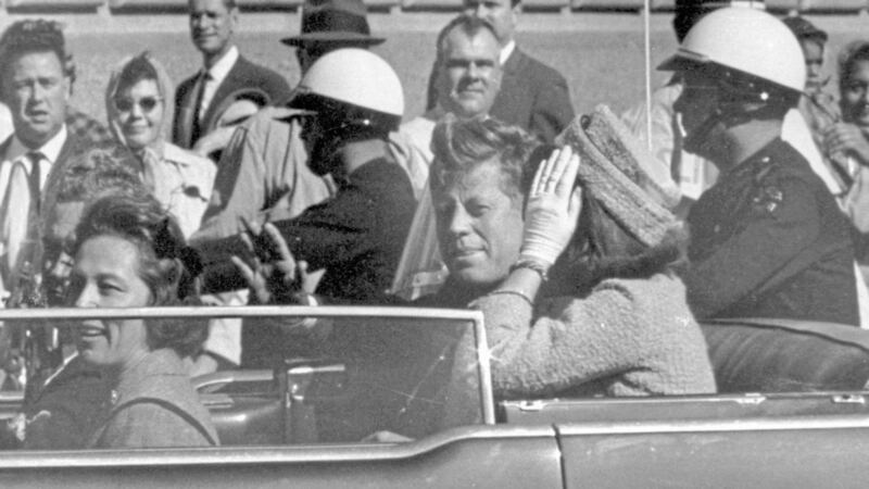 Former US president John F Kennedy waves from his car moments before being shot. Picture by Jim Altgens, File, Associated Press 