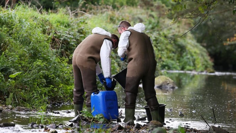 Clean-up work at the Annsborough River after a pollution leak from a NI Water sewage treatment plant caused the death of more than 1,600 fish at the weekend. Picture Mal McCann 