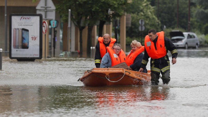 People are rescued in Longjumeau, south of Paris in floods that have left five people reported dead and thousands trapped in homes or cars, as rivers have broken their banks from Paris to Bavaria. Picture by Francois Mori/AP 