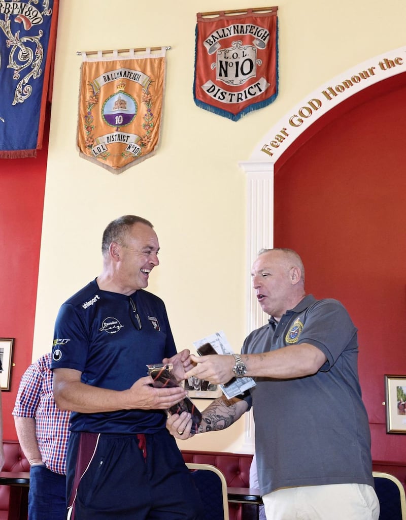 Malcolm McFarlane (left) chair of Bredagh GAC receiving a gift from Stephen Biggerstaff, Chair of the Ballynafeigh Cultural and Heritage Society. Picture by Michael Cooper, Press Association