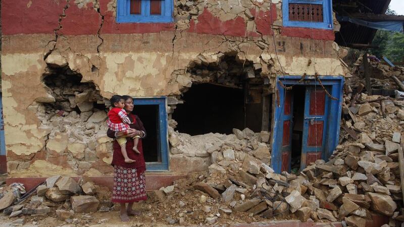 A woman and child outside their home damaged in April&#39;s earthquake on the outskirts of Lalitpur, Nepal Picture by Niranjan Shrestha/AP 