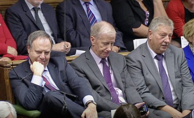 DUP MPs Nigel Dodds, Gregory Campbell, and Sammy Wilson listen as Prime Minister Boris Johnson delivers a statement about his Brexit deal in the House of Commons on Saturday. Picture by House of Commons/PA Wire 