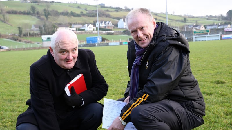 Down officials Sean Og McAteer and Brian McAvoy check the pitch before calling off the Dr McKenna Cup clash with UU in Burren Picture by Philip Walsh