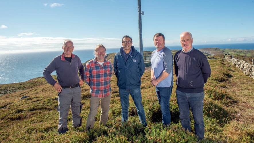 Cape Clear islanders and Vantage Towers chief executive Vivek Badrinath at the site of the new mast (Micheal MacSweeney/PA)