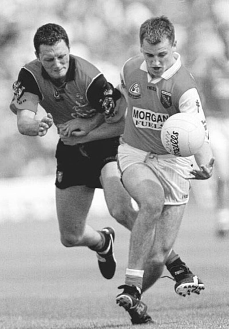 PADDY POWER...Armagh attacker Paddy McKeever holds off Simon Poland during yesterday&rsquo;s Ulster final at Clones, Sunday August 1 1999. 