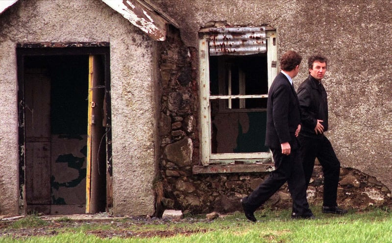 PACEMAKER BELFAST 19/02/98 A local parish priest (right) emerges from the Farm house in Aghalee near Portadown after giving the body of Kevin Conway the last rites this morning. Connolly's body was found late last night with his hands bound behind his back.