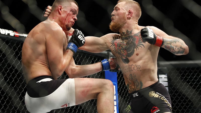 Conor McGregor trades punches with Nate Diaz during their UFC 196 welterweight mixed martial arts match in Las Vegas in March