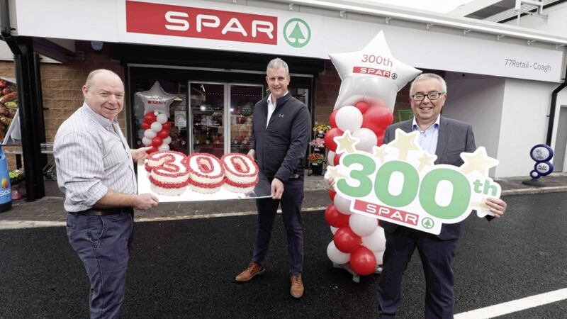 Spar Coagh owners Graham Johnson and Andy Davis celebrate the store being the 300th Spar to open in Northern Ireland. Included is Henderson Group joint managing director Martin Agnew. Picture: Matt Mackey/Presseye 