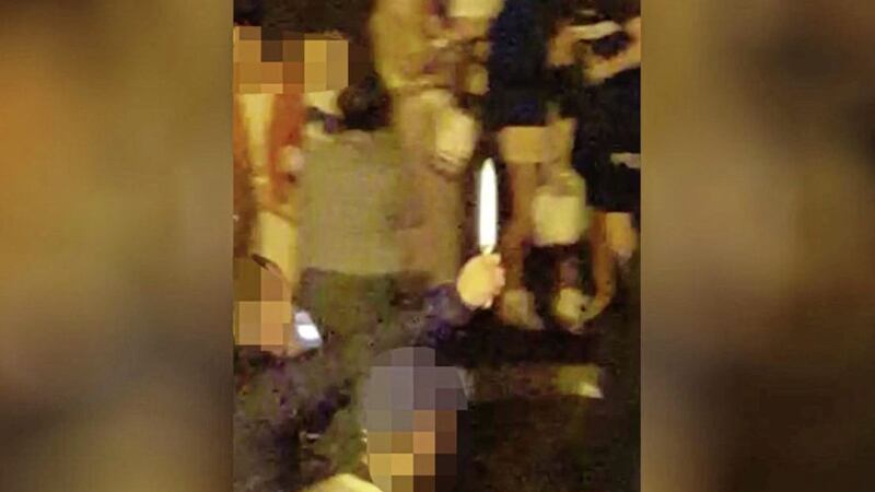 A still from a video which circulated on social media shows a man holding a knife 