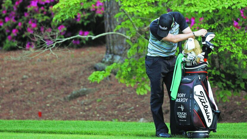 Rory McIlroy slumps over his bag on the 13th tee during the final round of the 2011 Masters, his four shot overnight lead having gone and his hopes for a first Major put on hold – for two months at least Picture by AP