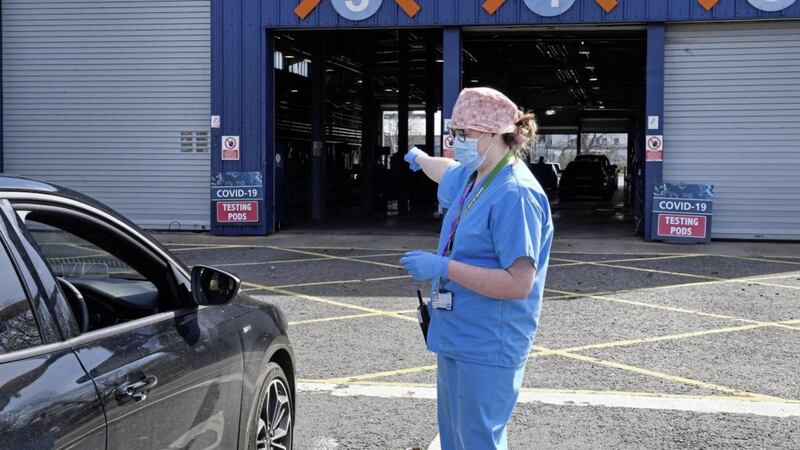 Medical staff direct cars at an MOT testing centre in Belfas which is being used as a drive through testing location for Covid-19. Picture by Justin Kernoghan/PA Wire. 