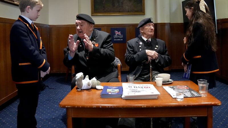 WW2 veterans Richard Aldred (left), 99, and Stan Ford (right), 98, meeting school children at a D-Day memorial event.
