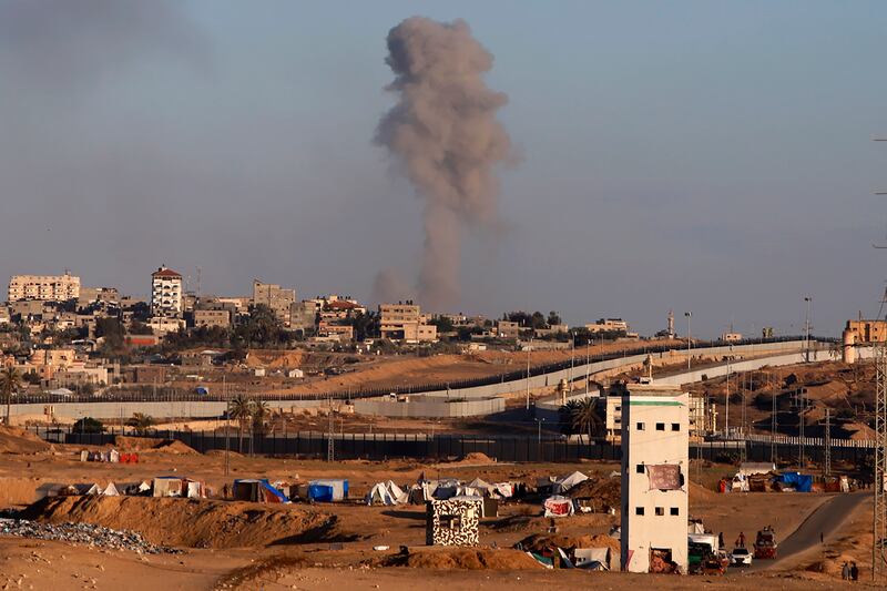 Smoke rises following an Israeli airstrike on buildings near the separating wall between Egypt and Rafah (Ramez Habboub/AP)