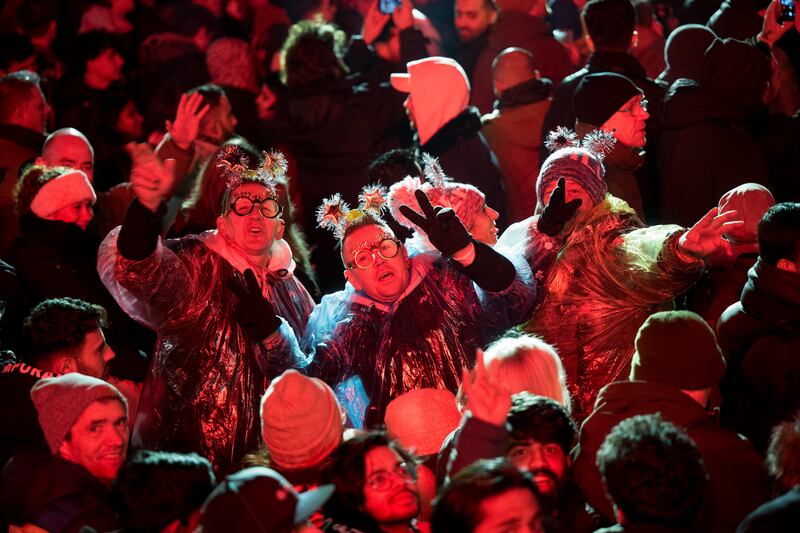People celebrate New Year’s Eve at the Brandenburg Gate party in Berlin (Sebastian Christoph Gollnow/dpa/AP)