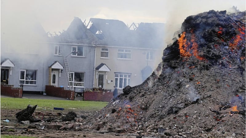 Terraced houses gutted last year close to an Eleventh Night bonfire in west Belfast. Picture by Hugh Russell 