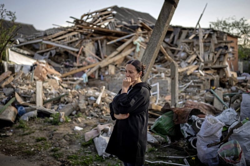 Anna Shevchenko (35) stands next to her home in Irpin, near Kyiv, which was was nearly completely destroyed by bombing by Russia in March last year 