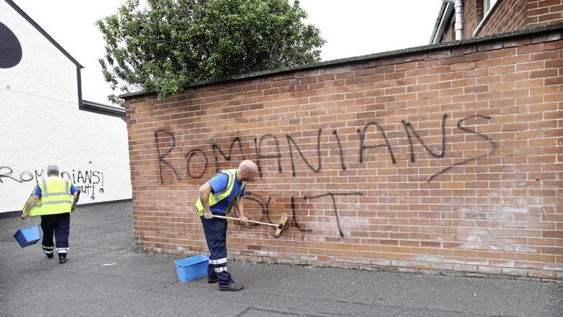 Racist graffiti being removed from walls in east Belfast in 2014. Picture by Hugh Russell 