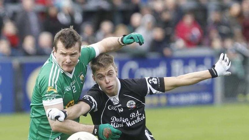 Burren's Dan McCartan tangles with Jerome Johnston of Kilcoo, McCartan expects his former Down team-mate to return to action on Friday night