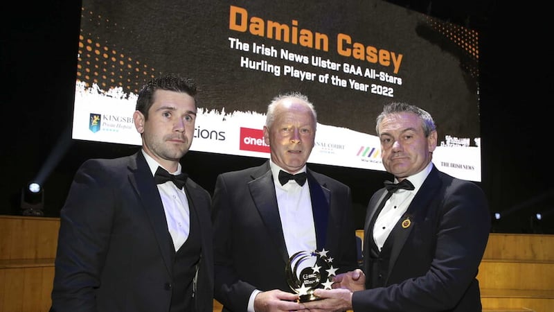 Damian Casey's father Sean receives the Hurling Player of the Year award from Ulster GAA President Ciaran McLaughlin. Also pictured is Damian's Tyrone team-mate and Irish News All-Star winner Chris Kearns    Picture: Hugh Russell