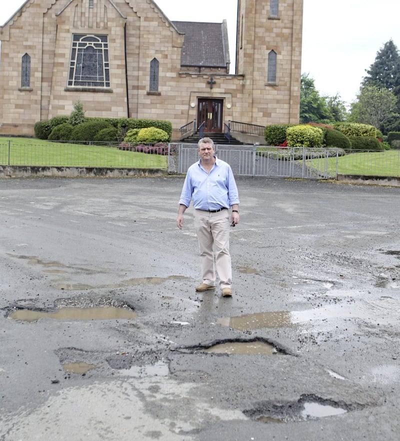 Martin Kelly beside some of the potholes. 