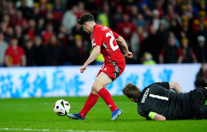 Daniel James rounds Finland goalkeeper Lukas Hradecky to score Wales’ fourth goal on Thursday