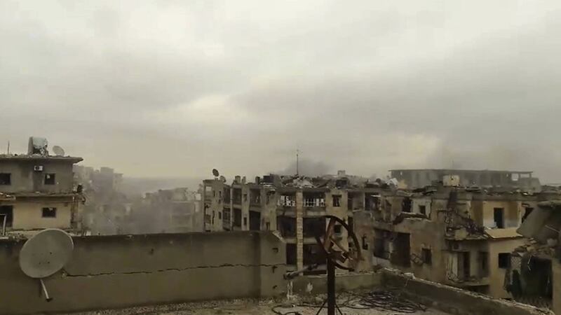 In this still image taken from video released by a Syrian activist Wednesday smoke rises in the distance alongside the sound of heavy bombardment in east Aleppo&nbsp;