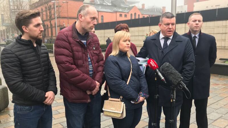 Relatives of Loughinisland victims pictured outside court with Sinn F&eacute;in MP Chris Hazzard and solicitor Niall Murphy