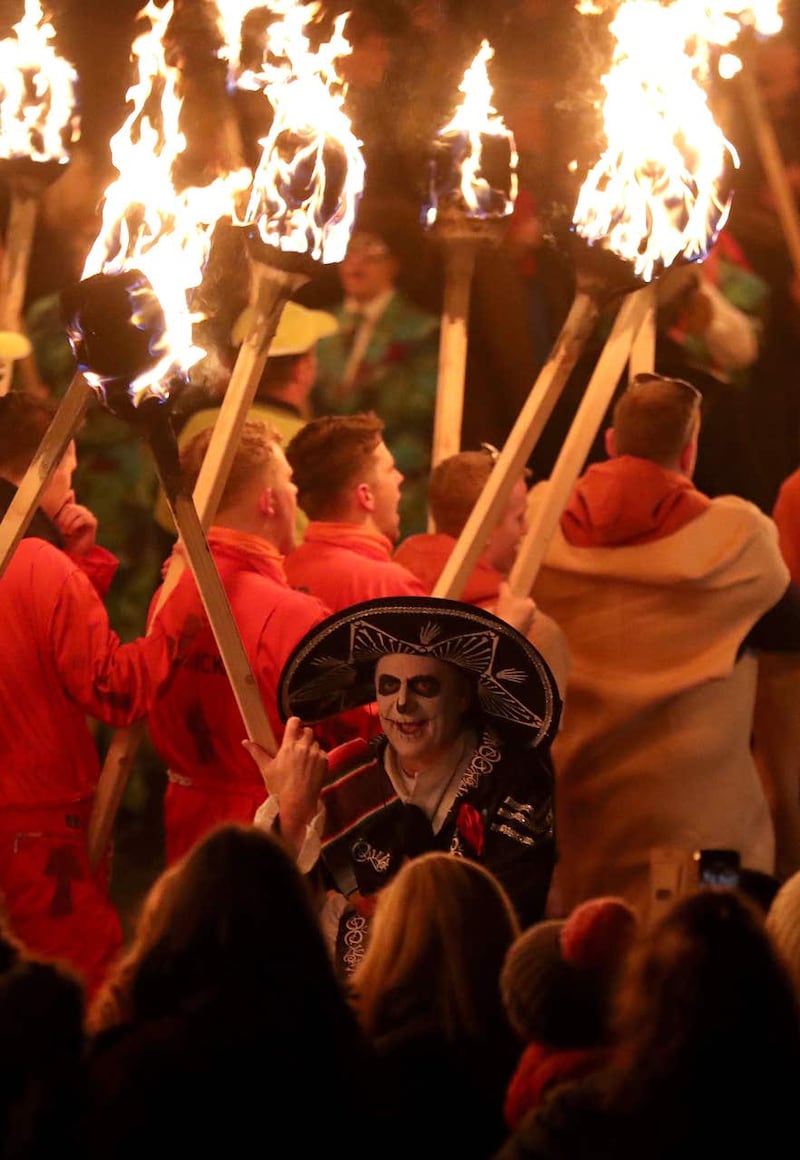 A squad member carries a torch as he marches through Lerwick ahead of the Galley being set on fire on Shetland Isles during the Up Helly Aa Viking festiva
