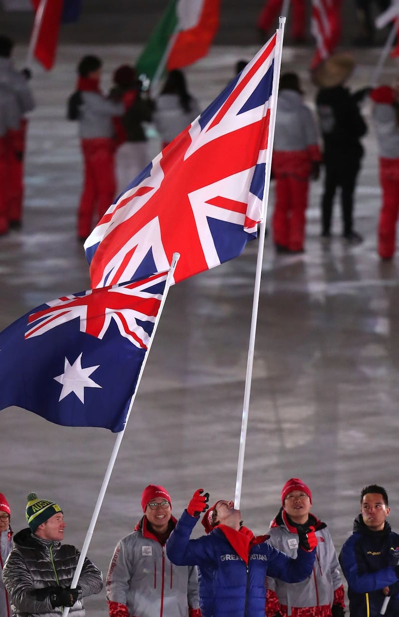 Great Britain's flagbearer Billy Morgan carries the flag on his chin during the closing ceremony of the Pyeongchang 2018 Winter Olympic Games in South Korea