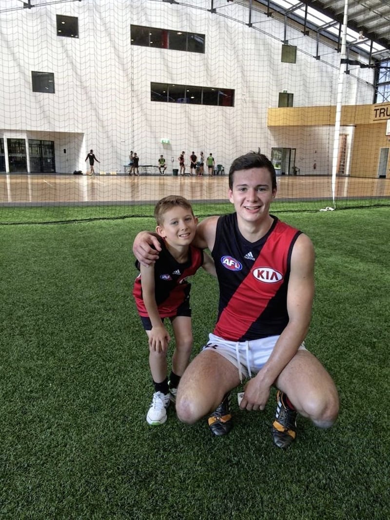 Conor McKenna with Barry Corr&#39;s son, Charlie, at Essendon 