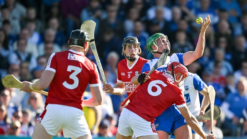 Michael Kiely of Waterford gets a handpass away while under pressure from Robert Downey and Ciaran Joyce of Cork during the Munster GAA Hurling Senior Championship Round 1 match between Waterford and Cork at Walsh Park in Waterford. Photo by Brendan Moran/Sportsfile