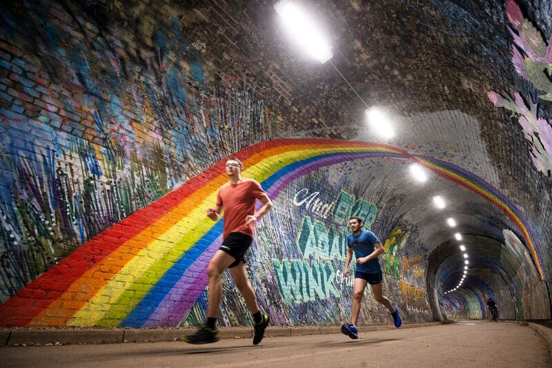 People jog through tunnel
