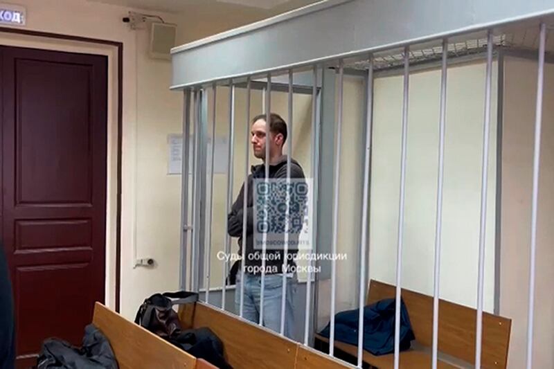 In this photo taken from video released by press service of lefortovsky court, Wall Street Journal reporter Evan Gershkovich, right, stands in a cage during a hearing at the court in Moscow, Russia on January 26 (AP)