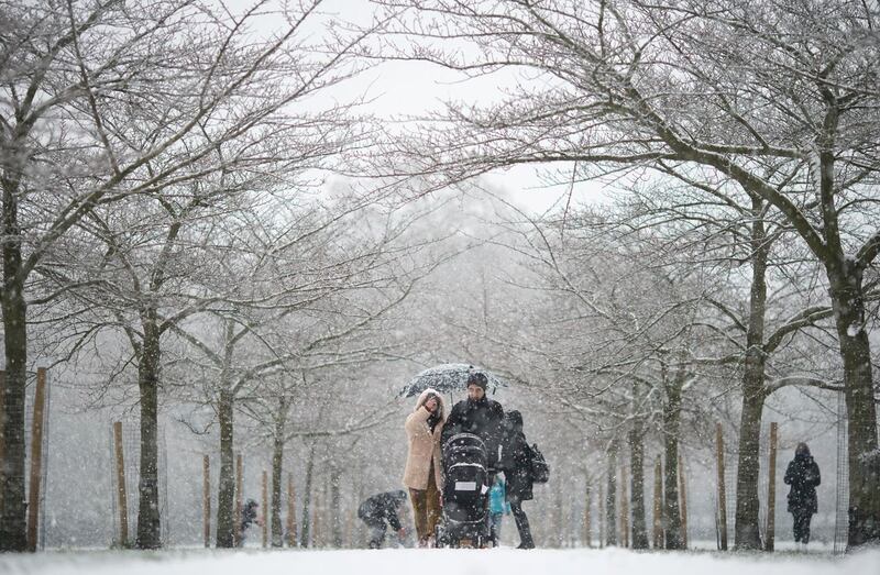 People walking in the snow in Battersea Park, London