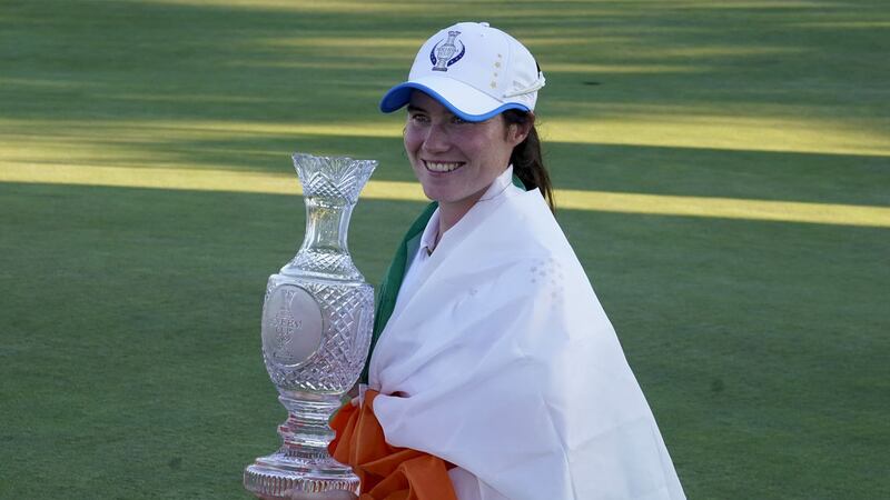&nbsp;Europe's Leona Maguire holds the trophy after playing a starring role in defeating the United States at the Solheim Cup golf tournament  in Toledo Ohio on Monday