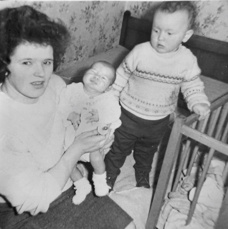 Ann McKane with baby Brian and toddler Damien in the iconic house