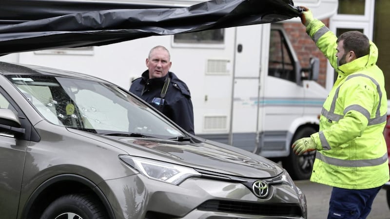Garda&iacute; cover the vehicle in which the man was shot to preserve it for evidence. Picture by Brian Lawless/PA 