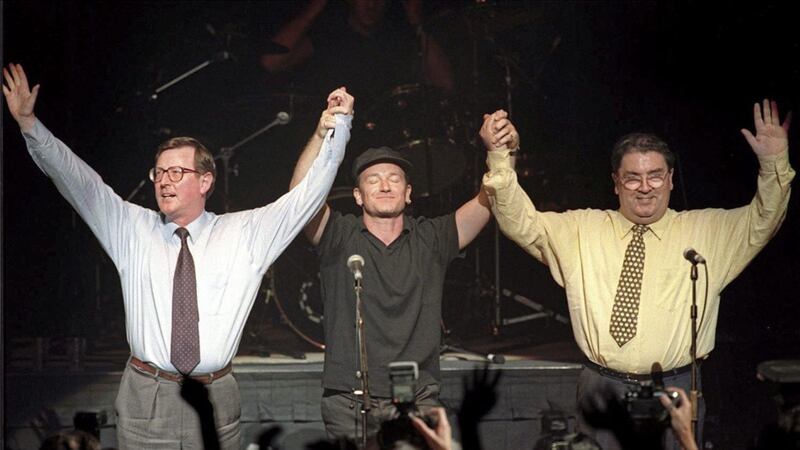 Bono holds aloft the arms of Ulster Unionist leader David Trimble SDLP leader John Hume on stage at Belfast&#39;s Waterfront Hall. Picture by Pacemaker 
