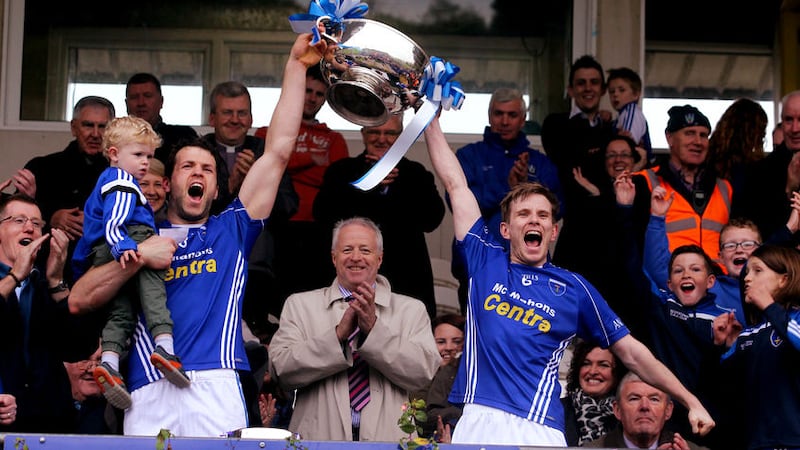 Scotstown's Donal Morgan (right) helps to lift the Mick Duffy Cup last year &nbsp;