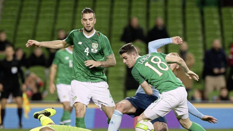 Republic of Ireland goalkeeper Darren Randolph (left) clears the ball under pressure from Northern Ireland's Liam Boyce&nbsp;