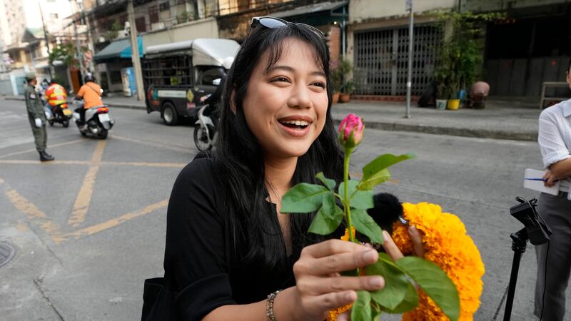 Patsaravalee Tanakitvibulpon receives a garland from her supporter on her arrival at Southern Criminal Court in Bangkok, Thailand, on Wednesday (Sakchai Lalit/AP)