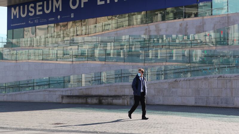 A man wearing a face mask walks past the Museum of Liverpool. The Liverpool City Region, comprising 1.6 million people.