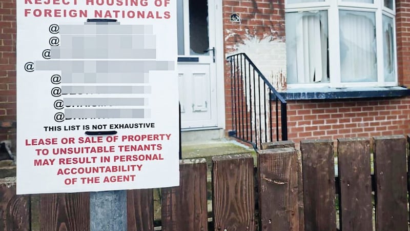 A racist poster outside a home in Moygashel, Co Tyrone with its windows smashed and graffiti sprayed on the walls 